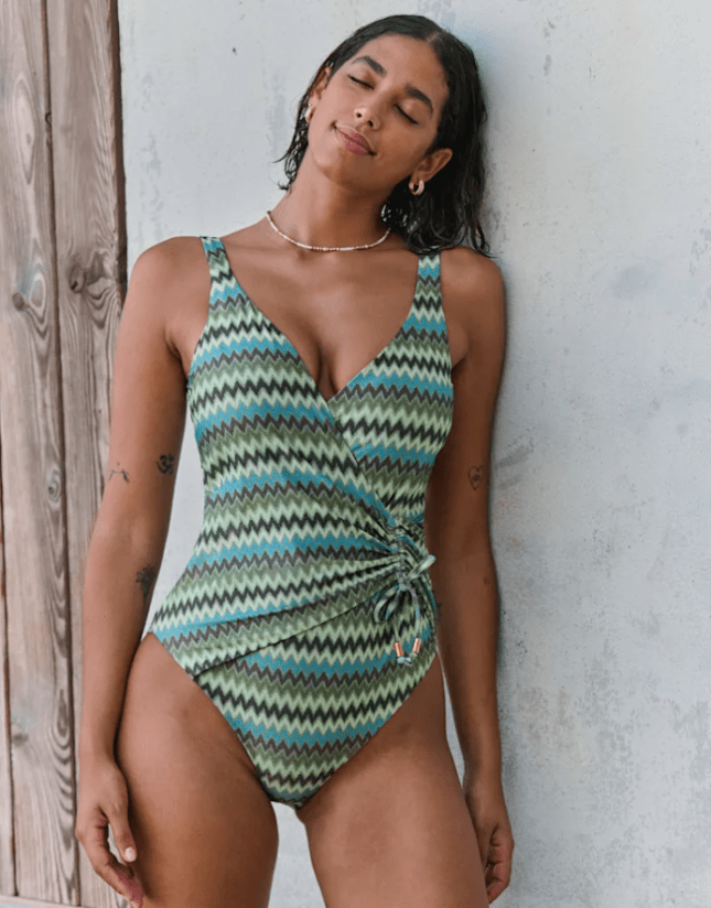 Female wears green printed swimming costume